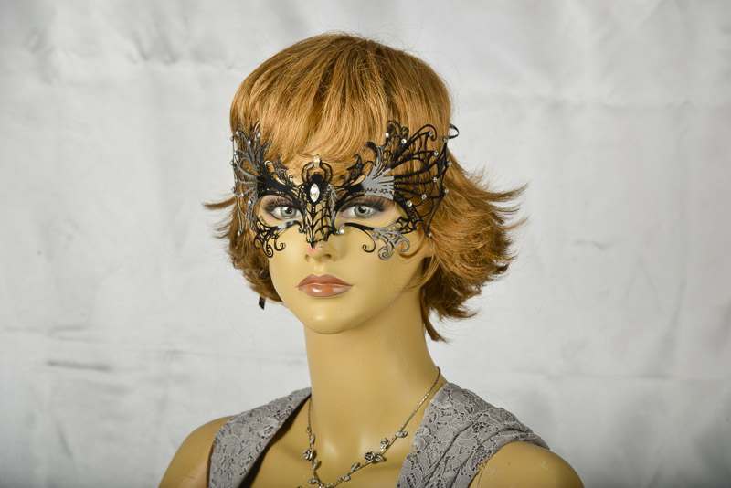 Black filigree metal Spider Venetian Masks on female face