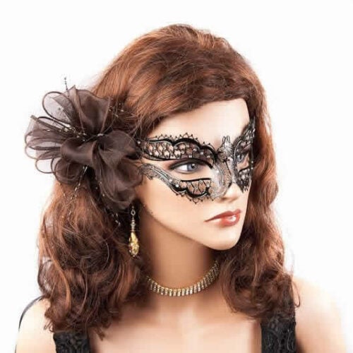 black filigree metal masquerade mask shown on a model