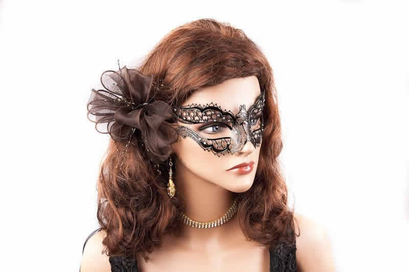 black filigree metal masquerade mask shown on a model