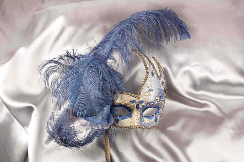 blue and gold feathered mask on stick