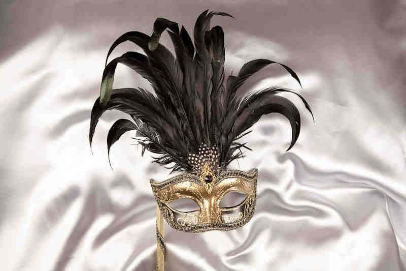 black and gold feathered mask on stick for women