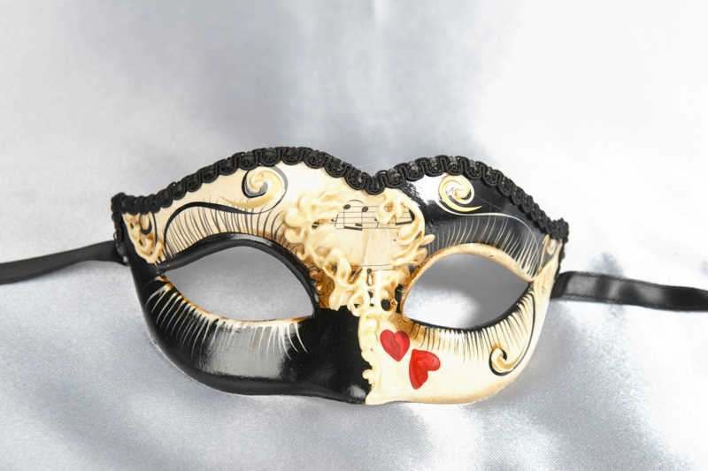 small masquerade mask with heart decoration in black