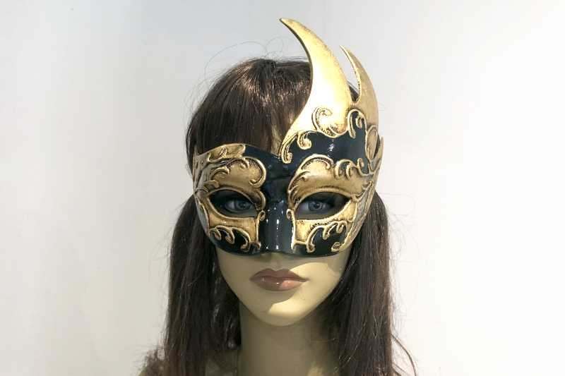 swan shaped animal masquerade mask in black and gold on female face