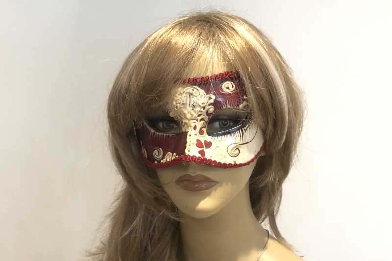 Colombina masquerade mask with heart decoration on female face
