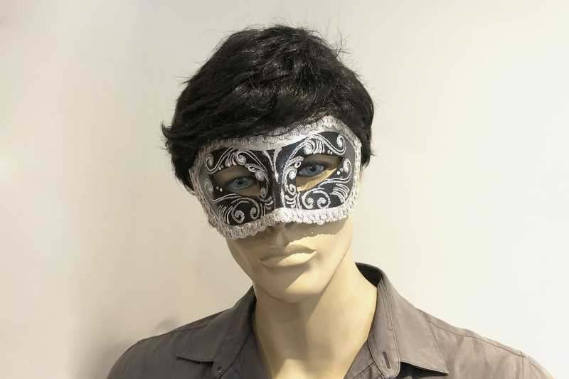 Silver Colombina masquerade mask with glitter and braiding on male face