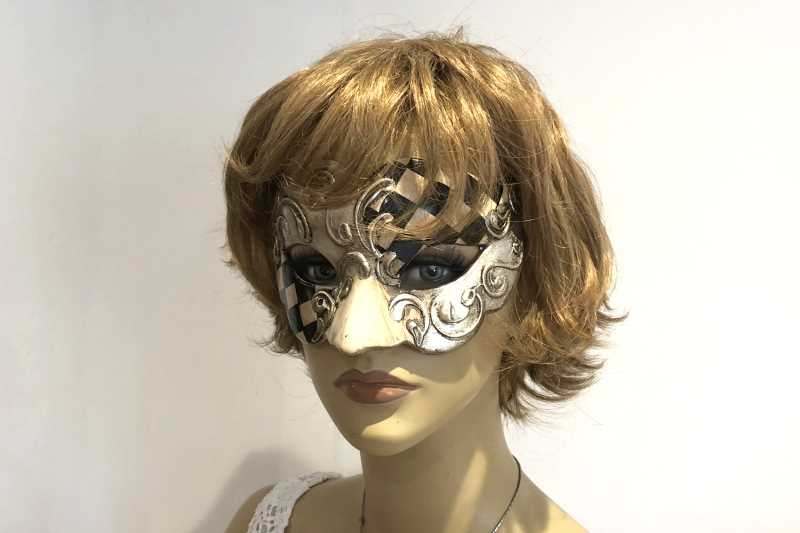 Carnvial masquerade mask with black and white diamond checks on female face
