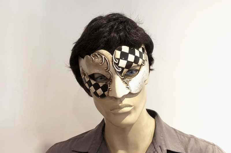 Carnvial masquerade mask with black and white diamond checks on male face