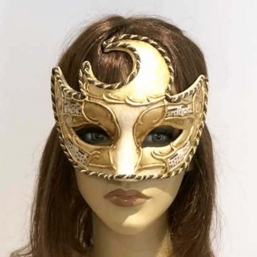 Moon shaped masquerade mask in gold and cream shown on female face