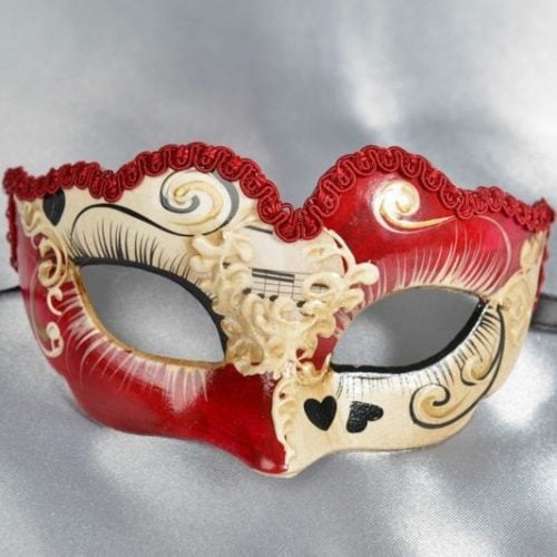 small masquerade mask with heart decoration in red